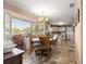 Bright dining room with chandelier lighting and large bay window at 11620 Sw 84Th Avenue Rd, Ocala, FL 34481