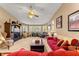 Spacious living room featuring a large picture window, ceiling fan and comfortable seating at 11620 Sw 84Th Avenue Rd, Ocala, FL 34481