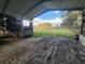 Interior view of the carport, showcasing its structure and potential for storage or workspace at 13521 N Magnolia Ave, Citra, FL 32113