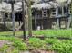 Exterior view of a rustic chicken coop, surrounded by green foliage and a wire fence at 13521 N Magnolia Ave, Citra, FL 32113