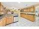 Bright kitchen featuring ample cabinet space, sleek appliances, and tile flooring throughout the room at 13521 N Magnolia Ave, Citra, FL 32113