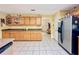 Functional kitchen featuring tile flooring, plentiful storage, and essential appliances for everyday cooking at 13521 N Magnolia Ave, Citra, FL 32113