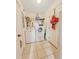 Functional laundry room with appliances, neutral tile flooring, and plenty of space for storage at 13521 N Magnolia Ave, Citra, FL 32113