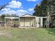 Exterior of a small outbuilding with a door, showcasing outdoor storage potential at 13521 N Magnolia Ave, Citra, FL 32113