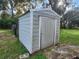 Exterior of a metal storage shed with a door, perfect for secure outdoor storage at 13521 N Magnolia Ave, Citra, FL 32113