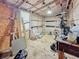 A workshop interior with ample space for projects and storage, illuminated by ceiling lights at 13521 N Magnolia Ave, Citra, FL 32113