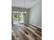 Bright dining room with wood-look floors and sliding glass door leading to the patio at 13936 Sw 113 Ln, Dunnellon, FL 34432