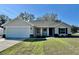 Charming single-story home with neutral paint, attached two-car garage, and manicured lawn at 13936 Sw 113 Ln, Dunnellon, FL 34432