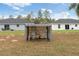 View of backyard showing a small storage shed in the yard between two houses at 14404 Sw 19Th Pl, Ocala, FL 34481