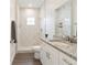 Bathroom featuring a shower with marble-look tiling and a modern vanity with a white granite countertop at 14404 Sw 19Th Pl, Ocala, FL 34481