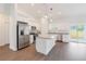 Modern kitchen featuring stainless steel appliances, white cabinets, granite countertops, and a center island at 14404 Sw 19Th Pl, Ocala, FL 34481