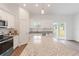 Modern kitchen featuring stainless steel appliances, granite countertops, a kitchen island, and access to the backyard at 14404 Sw 19Th Pl, Ocala, FL 34481