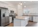 Bright kitchen showcasing white cabinetry, granite countertops, stainless steel appliances, and pendant lighting at 14404 Sw 19Th Pl, Ocala, FL 34481