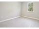 Clean, minimalist bedroom with natural light highlighting gray tiled floors at 16171 Sw 48Th Cir, Ocala, FL 34473