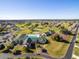 Wide aerial shot showcasing the clubhouse, pool, tennis courts, golf course, and surrounding community at 1921 Nw 50Th Cir, Ocala, FL 34482