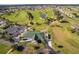 Aerial view of golf community with lush fairways and a clubhouse at 1921 Nw 50Th Cir, Ocala, FL 34482