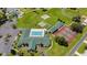 Aerial view of community amenities including a pool, tennis courts, and shuffleboard courts at 1921 Nw 50Th Cir, Ocala, FL 34482