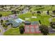 Aerial view of the clubhouse, pool, tennis courts, shuffleboard, golf course, and community layout at 1921 Nw 50Th Cir, Ocala, FL 34482