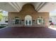 Inviting clubhouse entrance featuring double doors, arched windows, and a brick facade at 1921 Nw 50Th Cir, Ocala, FL 34482