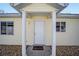 Inviting entrance with a covered porch and classic white door at 1921 Nw 50Th Cir, Ocala, FL 34482