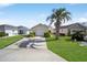 Charming home with a well-manicured lawn and a beautiful palm tree in the front yard at 1921 Nw 50Th Cir, Ocala, FL 34482