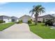 Charming home with a well-manicured lawn and a beautiful palm tree in the front yard at 1921 Nw 50Th Cir, Ocala, FL 34482