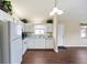 This kitchen is equipped with white appliances, cabinets, and modern hardwood flooring at 1921 Nw 50Th Cir, Ocala, FL 34482