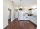 Bright kitchen features white appliances, cabinetry, and sleek hardwood flooring at 1921 Nw 50Th Cir, Ocala, FL 34482