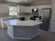 Modern kitchen featuring white cabinetry, stainless steel appliances, and quartz countertops at 2 Walnut Run, Ocala, FL 34472