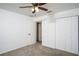 A cozy bedroom featuring a ceiling fan, closet, neutral carpeting, and white walls at 20260 Sw 95Th St, Dunnellon, FL 34431