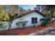 View of the home's address. Featuring a textured facade with mulch beds at 20260 Sw 95Th St, Dunnellon, FL 34431