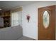 Inviting foyer featuring a decorative front door, neutral walls, and a glimpse of the living room at 20260 Sw 95Th St, Dunnellon, FL 34431