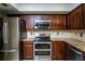 Well-equipped kitchen featuring stainless steel appliances, granite countertops, and stylish tile backsplash at 20260 Sw 95Th St, Dunnellon, FL 34431