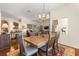 Open concept dining area featuring a spacious wood table with a view of the living room and outdoor scenery at 2310 Nw 59Th Ave, Ocala, FL 34482