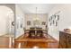 Formal dining room with a rustic wood table, seating for six, and decorative wall art at 2310 Nw 59Th Ave, Ocala, FL 34482