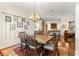 Cozy dining room featuring a wood table, comfortable seating, and unique wall decor at 2310 Nw 59Th Ave, Ocala, FL 34482