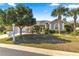 Attractive single-story home featuring mature landscaping, palm trees, and a two-car garage at 2310 Nw 59Th Ave, Ocala, FL 34482
