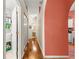 Hallway view into laundry room and bathroom on hardwood flooring at 2310 Nw 59Th Ave, Ocala, FL 34482