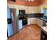 Well-equipped kitchen with stainless steel appliances, ample cabinetry, and tile flooring at 2310 Nw 59Th Ave, Ocala, FL 34482