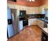 Well-equipped kitchen features stainless steel appliances, ample cabinet space and tile floors at 2310 Nw 59Th Ave, Ocala, FL 34482