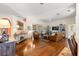 Open living room filled with natural light features hardwood floors and comfortable leather seating at 2310 Nw 59Th Ave, Ocala, FL 34482