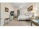 Well-lit main bedroom with a ceiling fan, sitting area, desk and a view to the bathroom at 2310 Nw 59Th Ave, Ocala, FL 34482