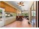 Bright sunroom featuring tiled floor, ceiling fans, bamboo shades, and sliding glass door to the outdoor patio at 2310 Nw 59Th Ave, Ocala, FL 34482