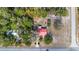 Top-down aerial of house with red metal roof among dense trees at 23761 Sw Plaza Ct, Dunnellon, FL 34431