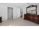 Cozy bedroom features large closet, neutral walls, and a classic dark wood dresser at 23761 Sw Plaza Ct, Dunnellon, FL 34431