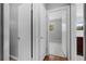 Hallway with neutral paint and flooring leading to a bedroom visible through the door at 23761 Sw Plaza Ct, Dunnellon, FL 34431