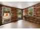 Unique wood-paneled room with multiple windows and a sliding glass door leading to the outdoors at 23761 Sw Plaza Ct, Dunnellon, FL 34431