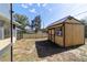 View of the fenced backyard with a large shed and screened-in patio of the house at 2620 Sw 152Nd Ln, Ocala, FL 34473