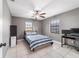 Cozy bedroom with tile flooring, ceiling fan, and multiple windows that let in natural light at 2620 Sw 152Nd Ln, Ocala, FL 34473