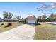 Home featuring a two-car garage and stone accents around front door with an expansive driveway at 2620 Sw 152Nd Ln, Ocala, FL 34473